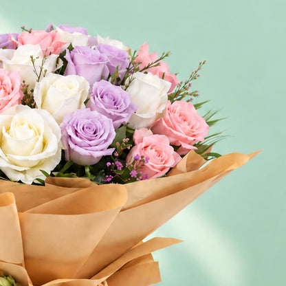 Mixed-colour roses arranged in a bouquet with non-woven wrapping
