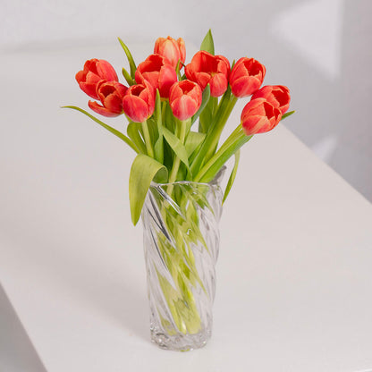 Vibrant orange cut tulips with rich citrus petals arranged in a vase