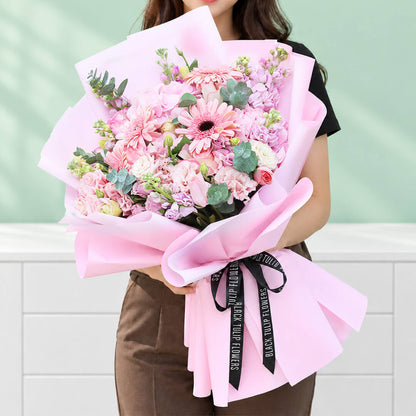Mixed flower bouquet with hydrangeas, roses, gerberas, eustoma, snapdragons and greenery
