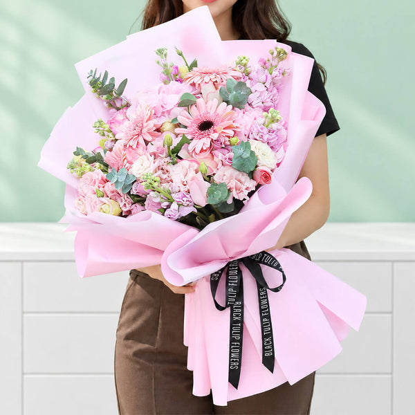 Mixed flower bouquet with hydrangeas, roses, gerberas, eustoma, snapdragons and greenery