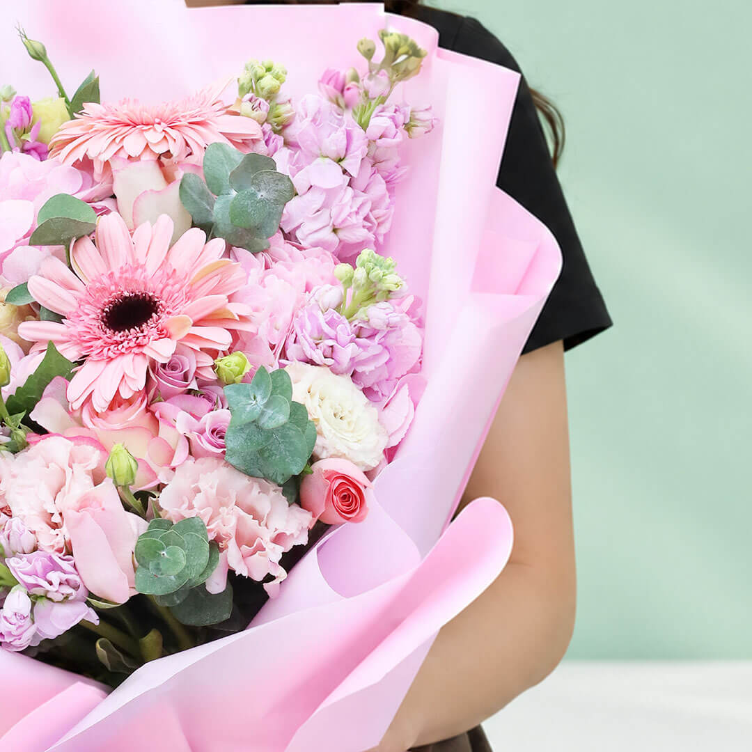 Mixed flower bouquet with hydrangeas, roses, gerberas, eustoma, snapdragons and greenery