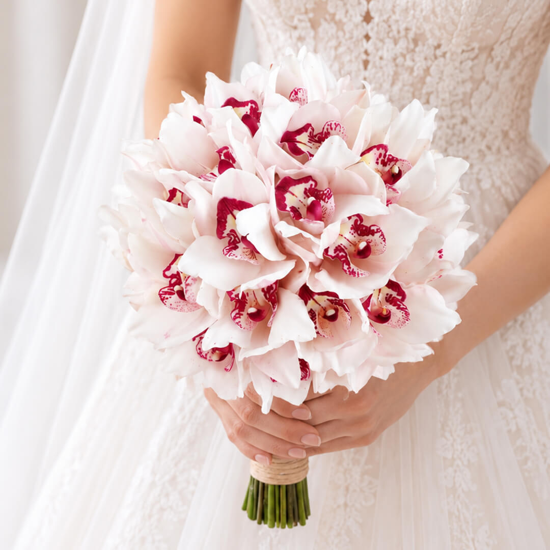 Hand-tied bridal bouquet of 5 pink Cymbidium orchids with elegant wrapping