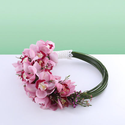 Elegant circular bridal hoop with pink Cymbidium orchids and wax flowers