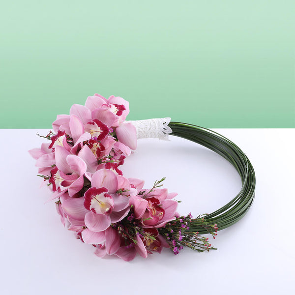 Elegant circular bridal hoop with pink Cymbidium orchids and wax flowers