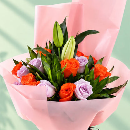 Lilies, Roses, and Green leaves combined as a bouquet and wrapped by non-woven paper