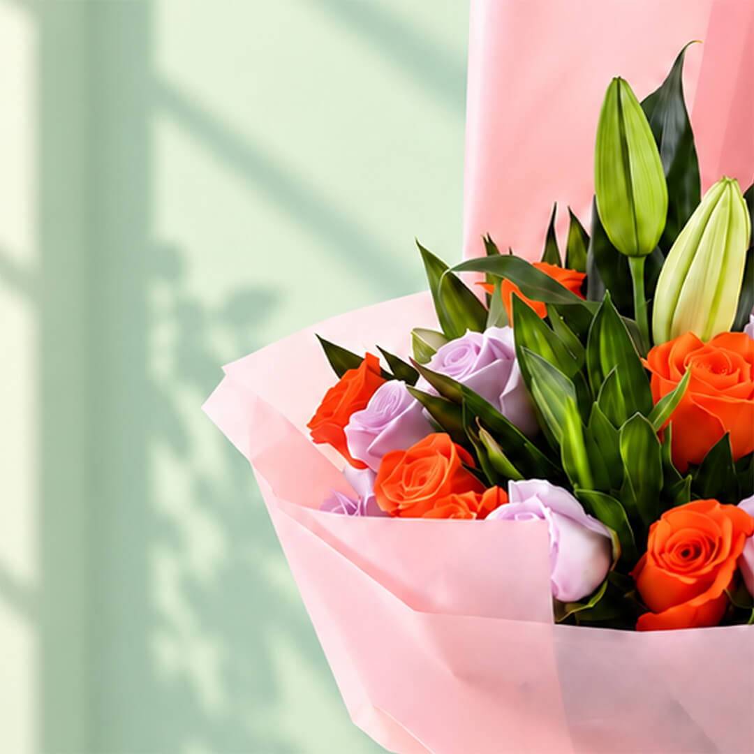 Lilies, Roses, and Green leaves combined as a bouquet and wrapped by non-woven paper