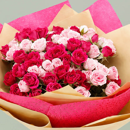 Pink spray rose bouquet with layered wrapping and matching ribbons for special occasions