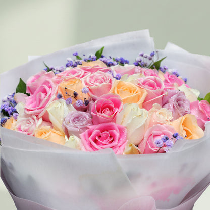 Assorted pastel roses and gypsophila bouquet with pink, peach, lavender, white and cream flowers