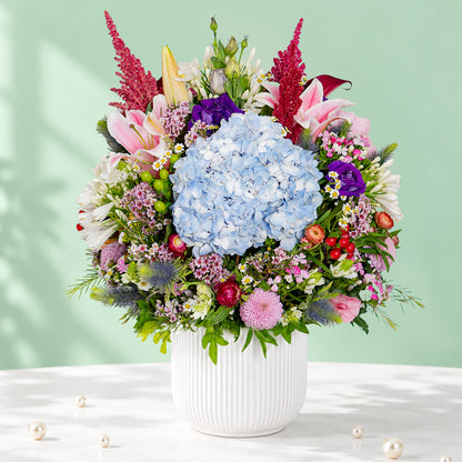 Exotic flower vase with protea, hydrangea, pincushion, lilies and greenery