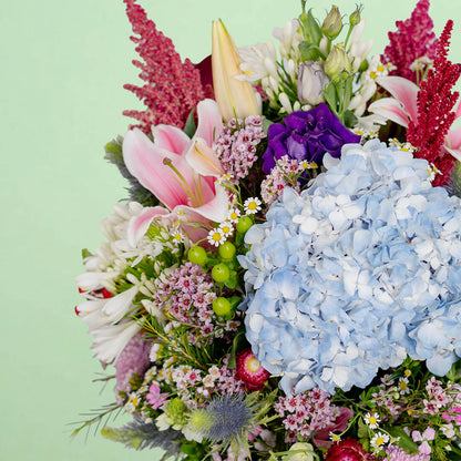 Exotic flower vase with protea, hydrangea, pincushion, lilies and greenery