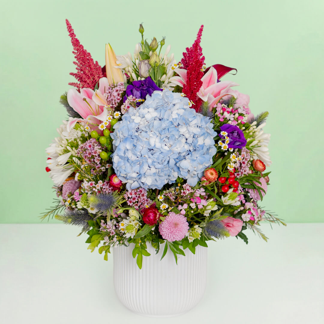 Exotic flower vase with protea, hydrangea, pincushion, lilies and greenery