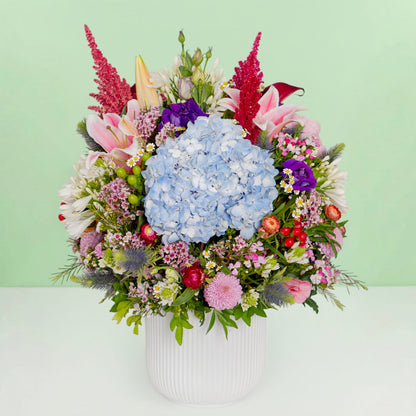 Exotic flower vase with protea, hydrangea, pincushion, lilies and greenery