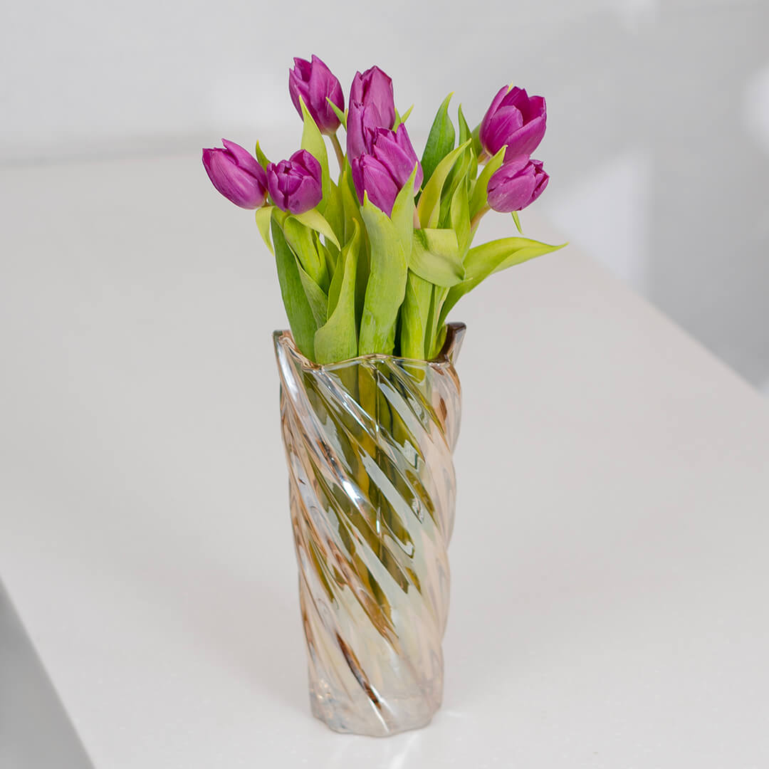 Deep purple cut tulip flowers featuring rich velvet petals and long green stems