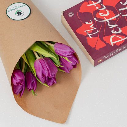 Deep purple cut tulip flowers featuring rich velvet petals and long green stems