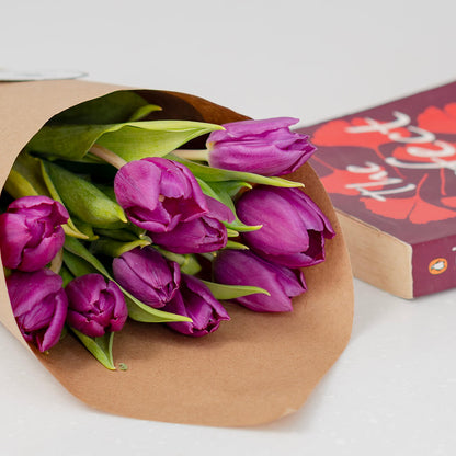 Deep purple cut tulip flowers featuring rich velvet petals and long green stems