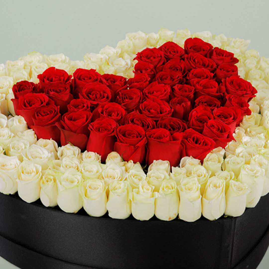 Red heart rose flower box with fresh red roses arranged beautifully for romantic gifting occasions