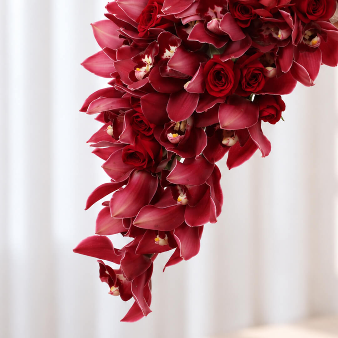 4 Red Cymbidium orchid stems wedding bouquet in a flowing cascade design