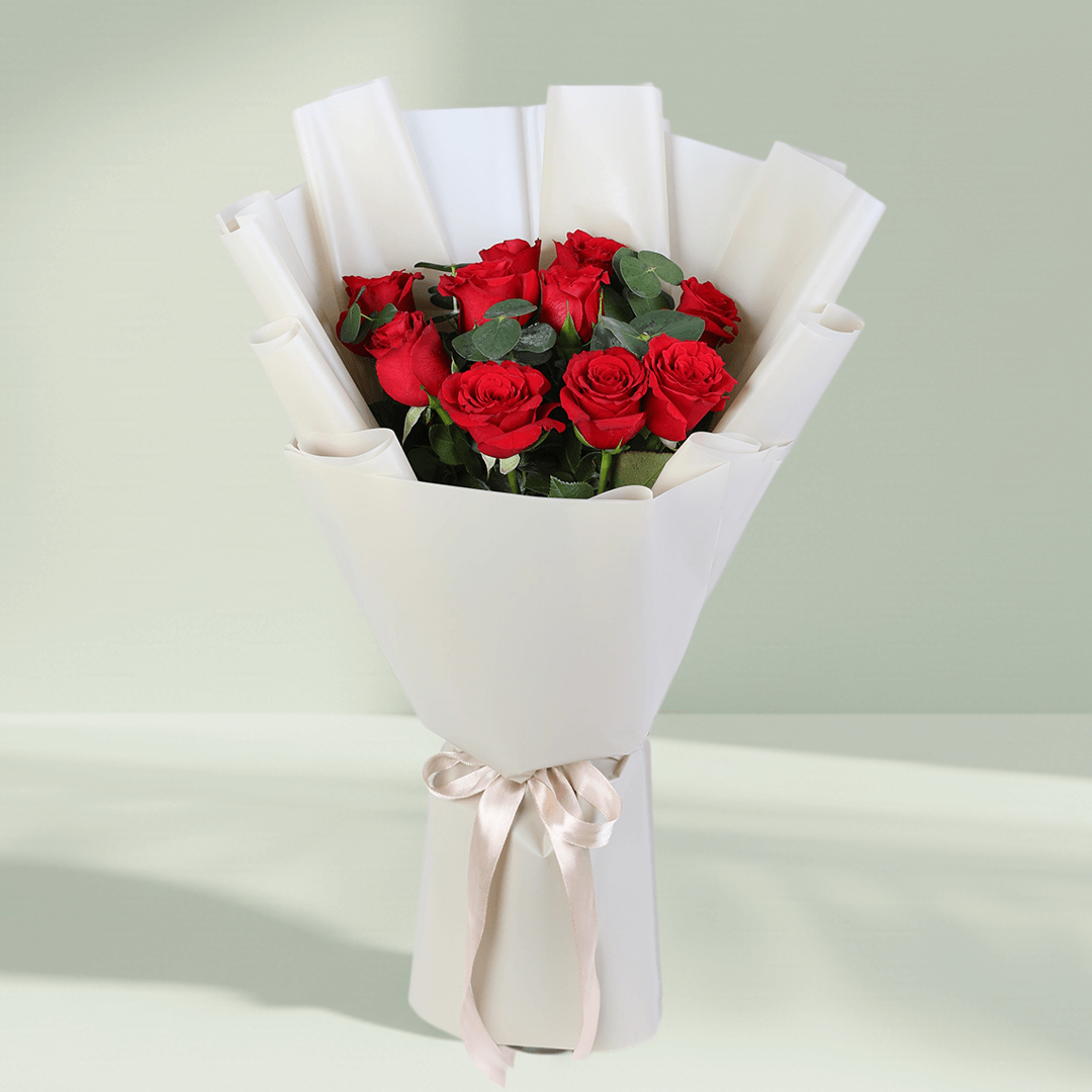 Red Roses Bouquet in White Wrap arranged with red roses with fresh greenery