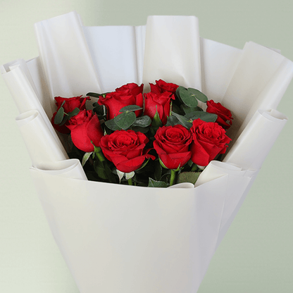 Red Roses Bouquet in White Wrap arranged with red roses with fresh greenery