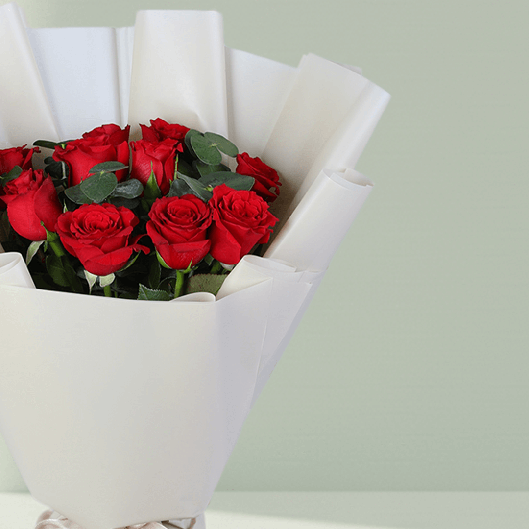 Red Roses Bouquet in White Wrap arranged with red roses with fresh greenery