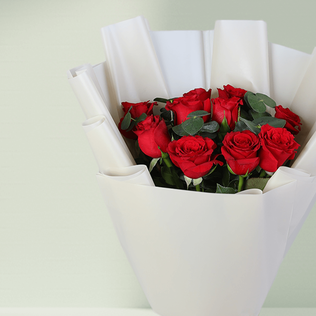 Red Roses Bouquet in White Wrap arranged with red roses with fresh greenery
