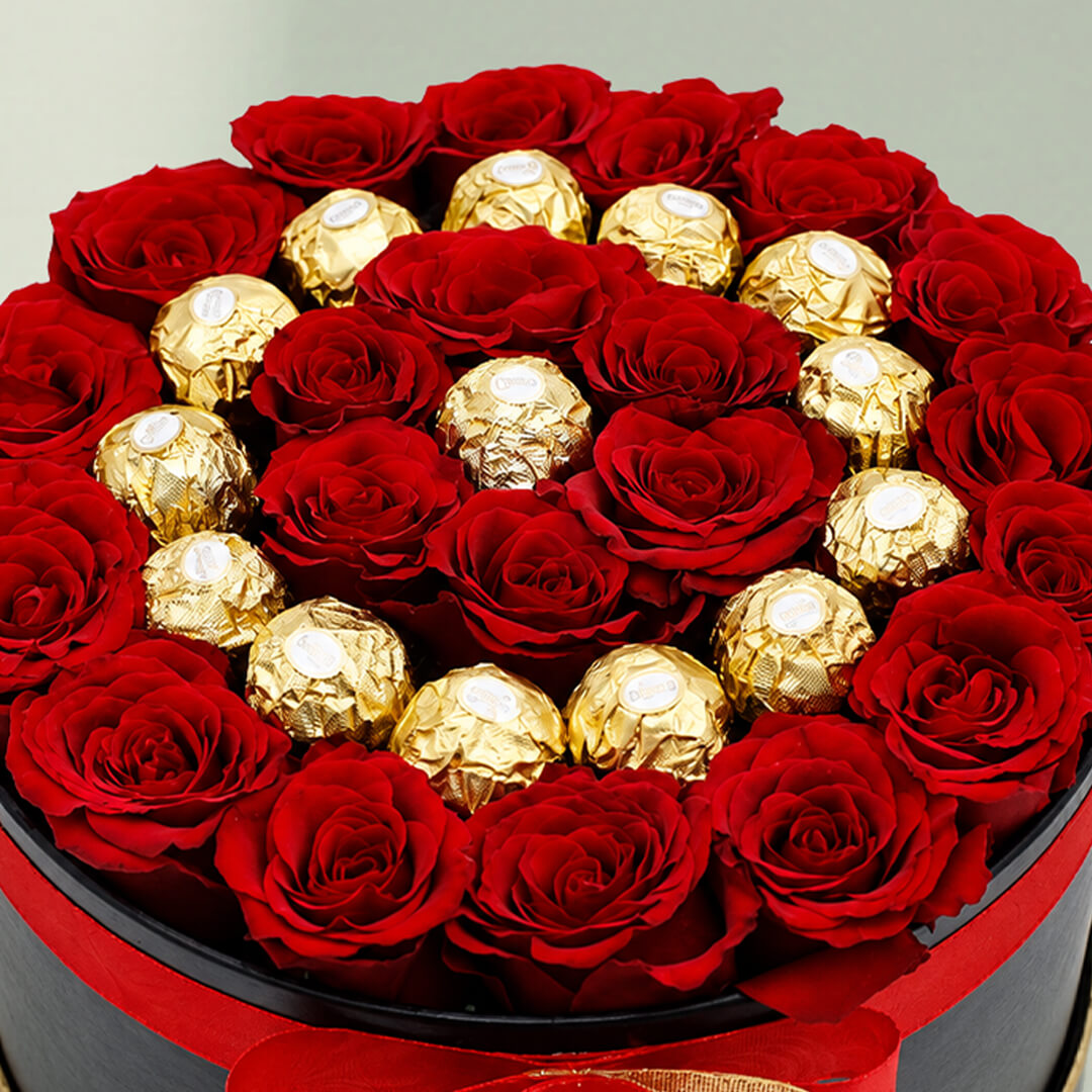 Red roses with 16 Ferrero Rocher chocolates arranged in a round gift box