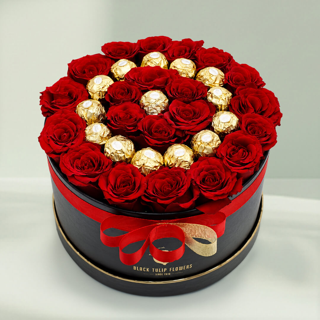 Red roses with 16 Ferrero Rocher chocolates arranged in a round gift box