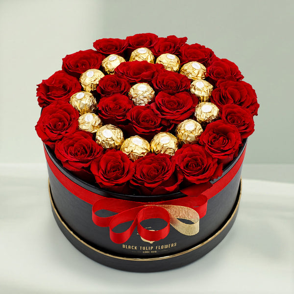Red roses with 16 Ferrero Rocher chocolates arranged in a round gift box