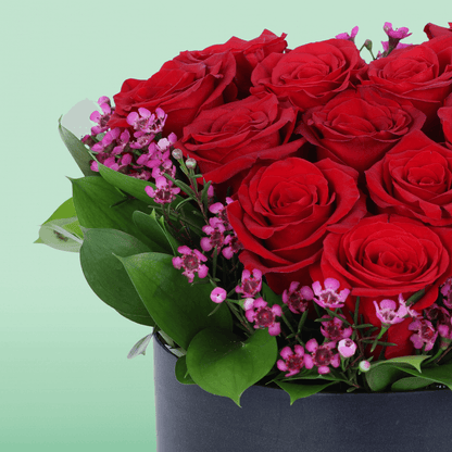 Red Roses Heart Love Box arranged with red roses with purple fillers