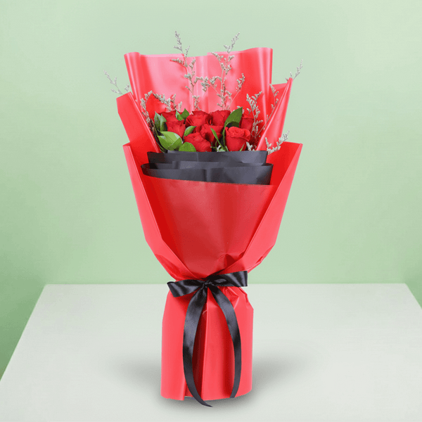 Red Roses in Red & Black Wrap arranged with red roses with fresh fillers