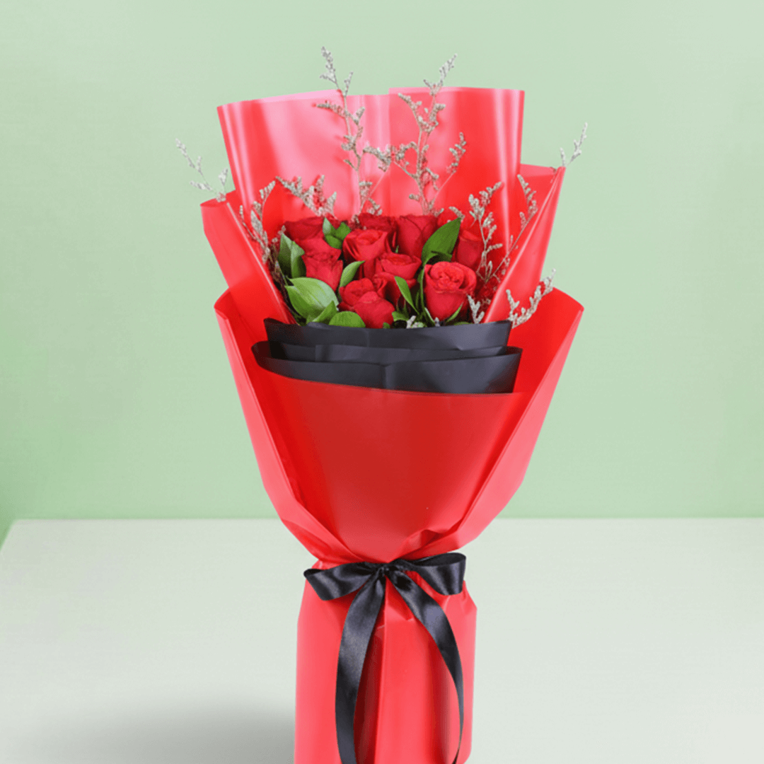 Red Roses in Red & Black Wrap arranged with red roses with fresh fillers