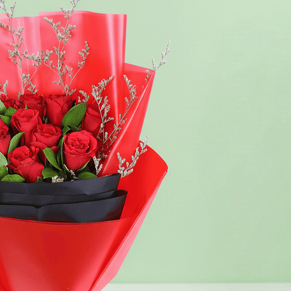 Red Roses in Red & Black Wrap arranged with red roses with fresh fillers