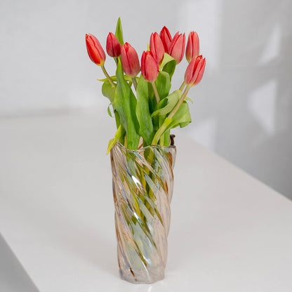 Deep red cut tulip flowers with fresh green stems and rich crimson petals