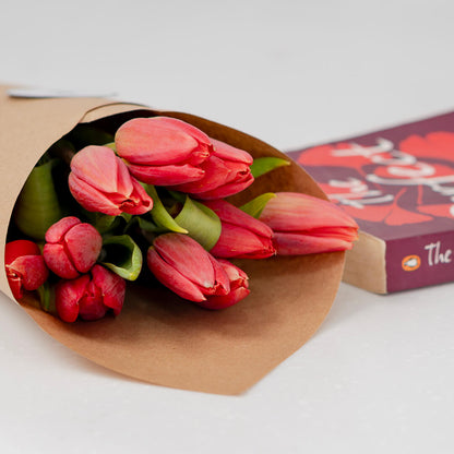 Deep red cut tulip flowers with fresh green stems and rich crimson petals