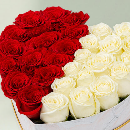 Red and white roses arranged equally in a heart-shaped marbled box for romantic gifting