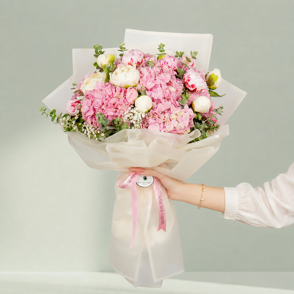 Pink peony bouquet with hydrangea and eucalyptus in Korean wrapping