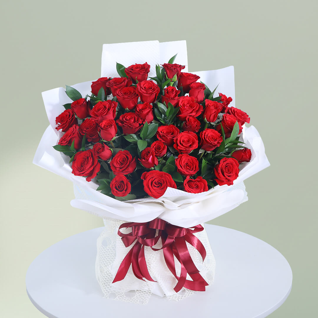 Romantic bouquet of 35 fresh red roses with greenery wrapped elegantly for special occasions