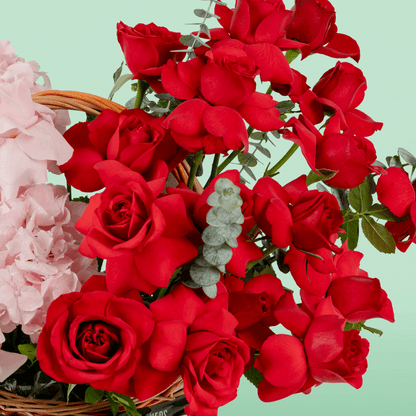 Mixed rose hydrangea basket with eucalyptus in red and pink flower tones
