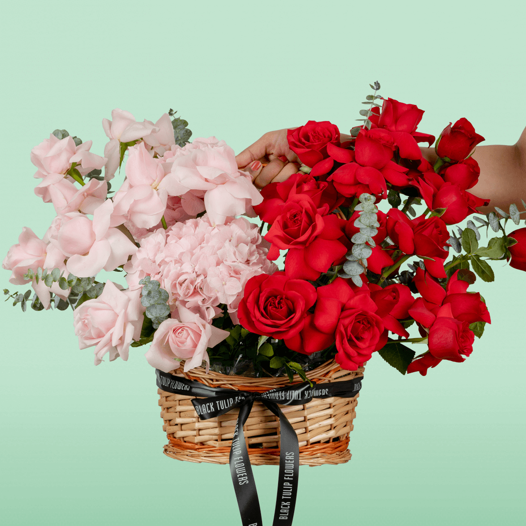 Mixed rose hydrangea basket with eucalyptus in red and pink flower tones