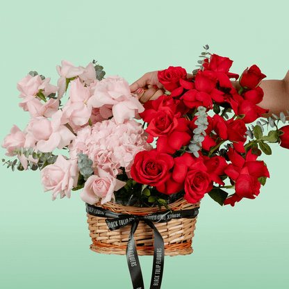 Mixed rose hydrangea basket with eucalyptus in red and pink flower tones
