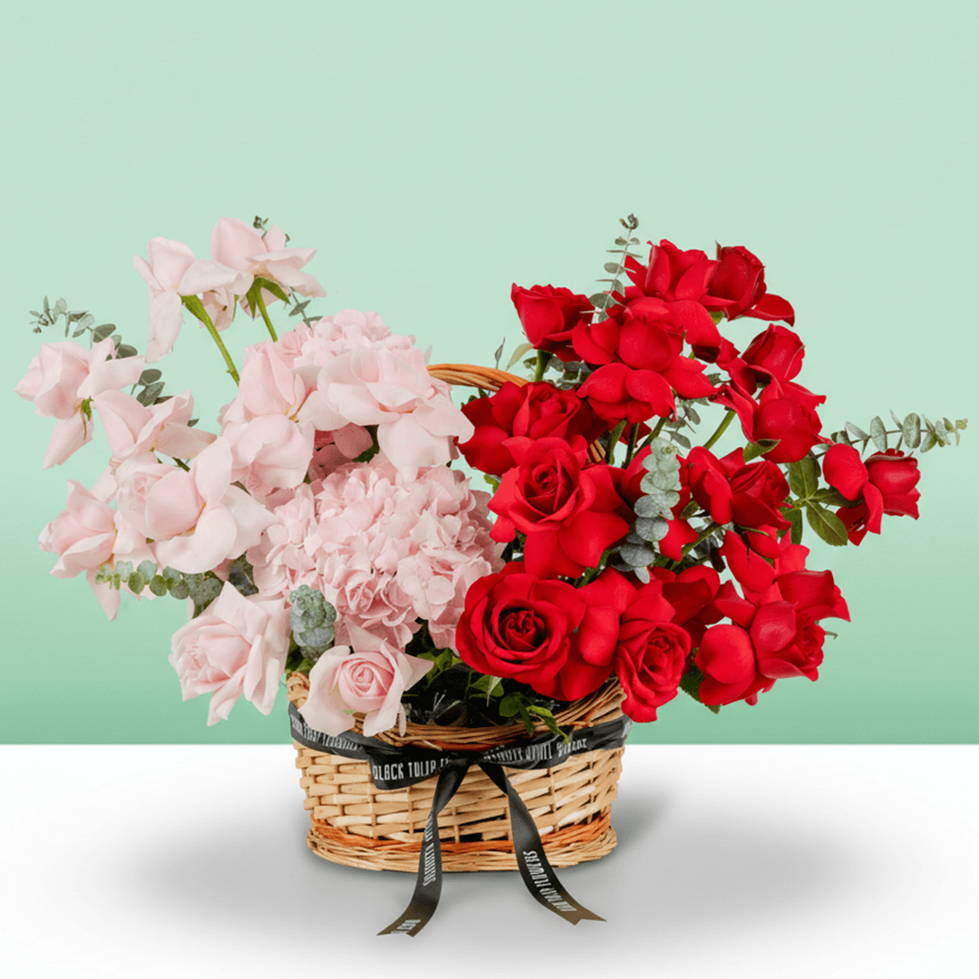 Mixed rose hydrangea basket with eucalyptus in red and pink flower tones