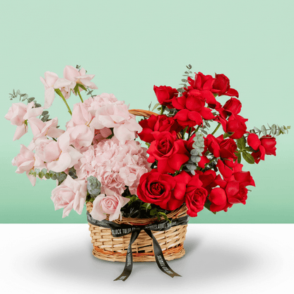 Mixed rose hydrangea basket with eucalyptus in red and pink flower tones