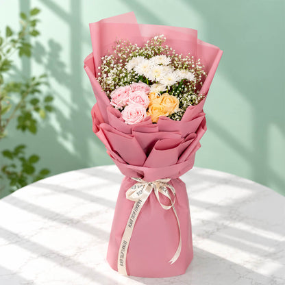 12-stem mixed flower bouquet featuring roses, chrysanthemums, and gypso in assorted colours, wrapped in Korean-style flower wrapping sheets.