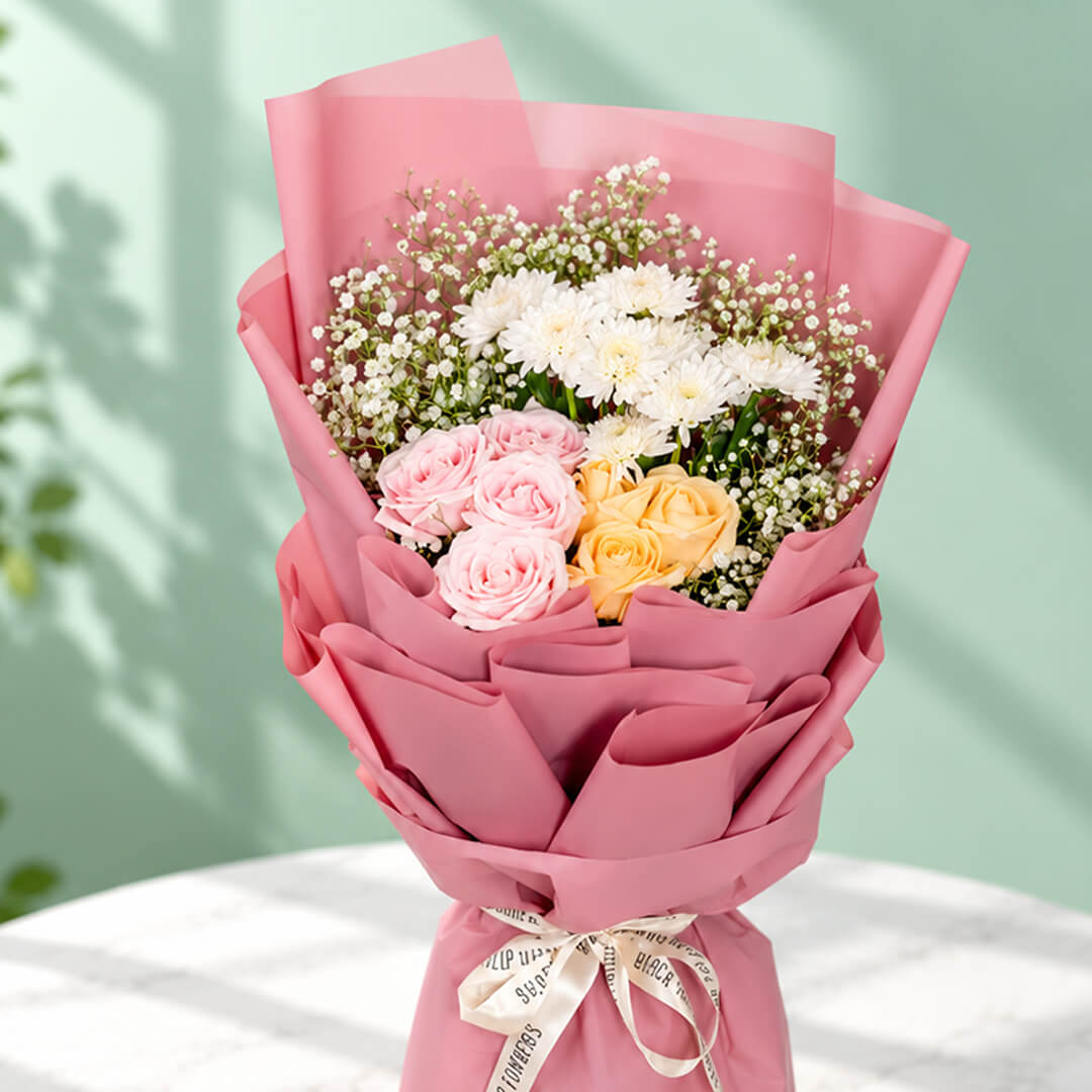 12-stem mixed flower bouquet featuring roses, chrysanthemums, and gypso in assorted colours, wrapped in Korean-style flower wrapping sheets.