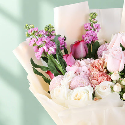 Mixed bouquet featuring hydrangea, stock, roses, spray roses and ping pong