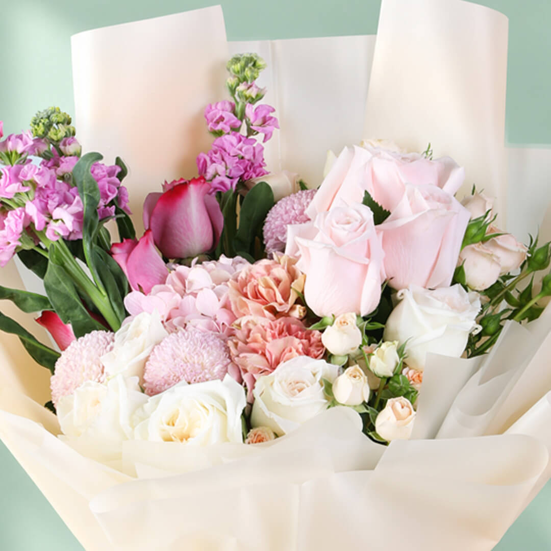 Mixed bouquet featuring hydrangea, stock, roses, spray roses and ping pong