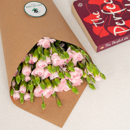 Fresh Spray Carnation blooms bundled in brown paper