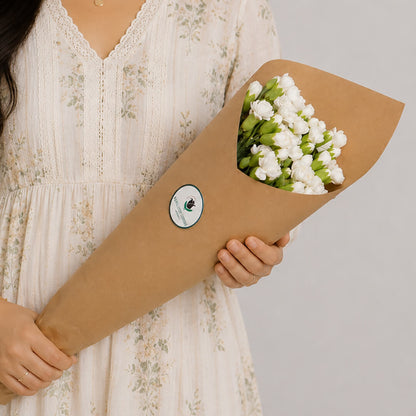 Fresh Spray Carnation blooms bundled in brown paper