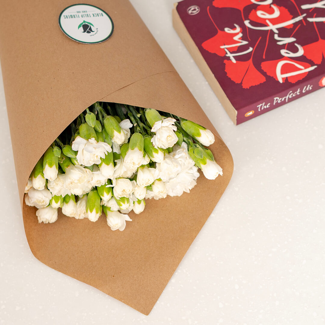 Fresh Spray Carnation blooms bundled in brown paper