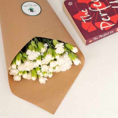 Fresh Spray Carnation blooms bundled in brown paper